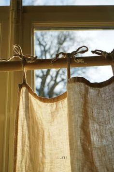 two curtains hanging from a rod in front of a window