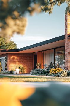 an artist's rendering of a brick house with large windows and plants in the front yard