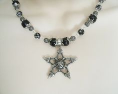 "This beautiful necklace has black pearl beads, black beads with silver engraved stars, seed beads, sterling silver plated filigree beads, pewter silver bead caps and a pewter silver pentagram. 18\" long. Sterling silver plated toggle clasp." Gothic Star-shaped Jewelry For Festivals, Gothic Black Star Necklace, Black Gothic Star Necklace, Gothic Silver Beaded Necklaces With Black Beads, Gothic Silver Jewelry With Black Beads, Gothic Silver Jewelry With Round Beads, Gothic Silver Beaded Necklace Perfect For Gifts, Silver Gothic Beaded Necklace For Gift, Silver Gothic Beaded Necklace As Gift