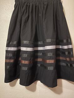 Native American Ribbon skirt- black, gray and brown ribbons. Ribbon Skirt - PLEASE CHOOSE YOUR SIZE BELOW! Skirt has an elastic waist that gives it the elusion of an A-line skirt.  Most skirts are 100% cotton or primarily cotton. Authentic Native American design for Pow Wow and Native American dances. They are approximately 32 inches long and most are about 32 inches in the waist.   RUSH SHIPPING: If you need to rush your shipping, (anything out of the normal) please note that I use USPS Priority Mail. You can change the shipping if you need to but please note, you will be charge for it and  I will also ask you to pay a RUSH fee. It is not fair to my other customers to have to move you to the front. There will be a fee of about $20 ($18 because shipping had to be added but I put in minimal Black Voluminous Skirt With Elastic Waistband, Black Gathered Mini Skirt, Casual Black Voluminous Skirt, Black Lined Flared Skirt, Black Tiered Lined Skirt, Long Black Skirt With Elastic Waistband, Black Long Skirt With Elastic Waistband, Black Pleated Full Skirt, Black Relaxed Lined Skirt