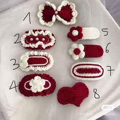 crocheted baby hats and booties are arranged on a white tray with numbers