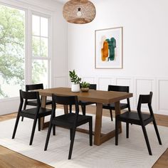 a dining table with four chairs and a potted plant in the middle of it