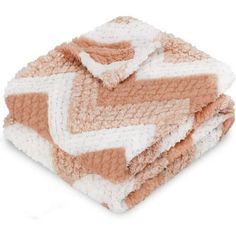 three blankets stacked on top of each other in different colors and patterns, one is brown and white