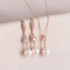 "* Beautiful rose gold filled wire wrapped round crystal pearl (8mm) dangle earrings complimented a cubic zirconia center bead and cubic zirconia accents down the center of the ear wire. This pair of earrings measure approximately 1 3/8\". * These earrings are paired with the matching necklace in 16\", 18\", or 20\" lengths. * Available in white (shown), cream (shown), creamrose (shown), light gold, rose gold (shown) crystal pearls. * TAKE 10% OFF $75 OR MORE WITH COUPON CODE ~ WEDDINGS10 * TAKE Pearl Wedding Jewelry Sets, Pearl Strands Necklace, Rose Gold Pearl, Pearl Rose, Pearl Jewelry Wedding, Gold Pearl Earrings, Wedding Jewelry Sets, Crystal Pearls, Rose Gold Earrings