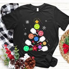 a t - shirt with an image of a christmas tree made out of ping pong paddles