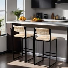 two stools in front of a kitchen counter with fruit on the plate and bowl of oranges