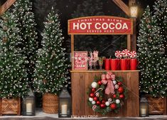 christmas decorations are on display in front of a hot cocoa stand