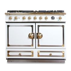 a white and gold stove top oven with two burners