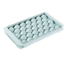 an egg tray filled with lots of white eggs