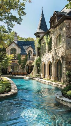 a large house with a pool in front of it and an arched window on the side