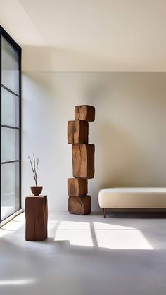 a living room filled with furniture and a tall wooden sculpture in front of a window