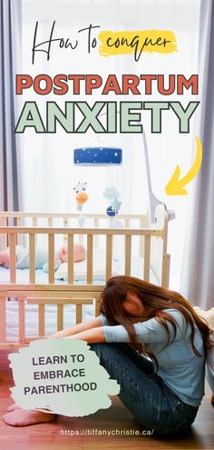 a woman sitting on the floor in front of a baby crib with her hands behind her head