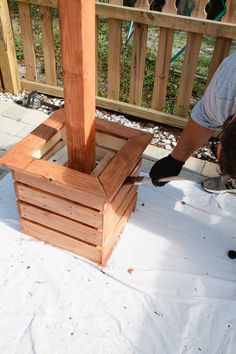 a man is working on a wooden structure