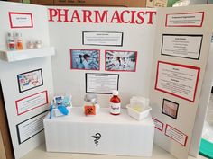 a table with some bottles and containers on it next to a sign that says pharmacist