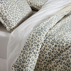 the comforter is made up with blue and white leopard print on it's sheets