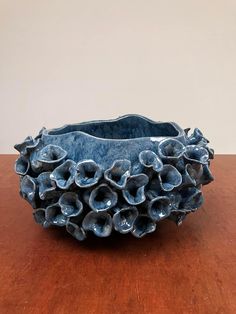 a blue vase sitting on top of a wooden table