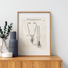 an art print on a shelf next to a vase