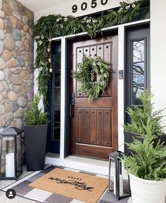 the front door is decorated with greenery and wreaths