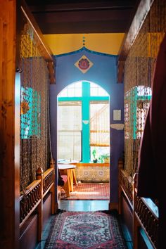 an archway leads into a brightly colored room