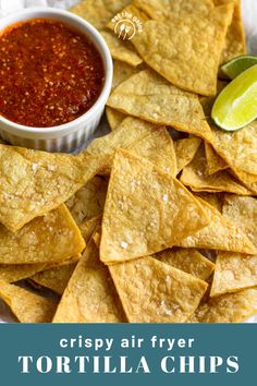 crispy air fryer tortilla chips on a plate with salsa and lime