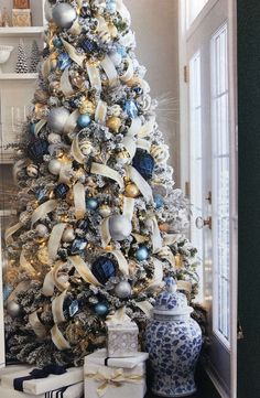 a decorated christmas tree with blue and white ornaments