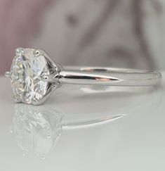 a white diamond ring sitting on top of a table