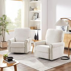 a living room with two white chairs and a coffee table