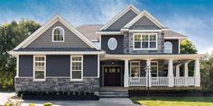 a house with gray siding and white trim on the front porch is shown in this rendering