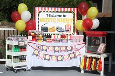 a movie night party with balloons and decorations