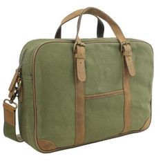 a green canvas bag with brown leather handles