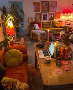 a living room filled with furniture and a laptop computer on top of a wooden table