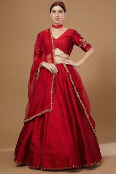 Red Embroidered Lehenga Set Featuring a red lehenga in raw silk base with hand embroidery. It is paired with a matching hand embroidered blouse and an organza dupatta. This product will be shipped to you after 1-2 weeks from the date of order placed. All custom made orders are not returnable. Pls contact for Size chart and for other more colors Request You :To provide contact details for courier services. {VARIATION MAY COME DEPENDING UPON AVALIBILITY OF LACES OR GOTTA PATI} NOTE:  1) Visual Samples on website may differ slightly from actual product due to light & effects during photography (Length & Breadth have 1 n 1.5 inches  +/-). 2) Before placing order ,pls confirm product n color availability on +91 7903893945 & +91 8447750028(WhatsApp) 3) For Wholesale Order MOQ is 5 Pieces of any Red Raw Silk Anarkali Set For Navratri, Red Raw Silk Traditional Wear With Sheer Dupatta, Red Tissue Silk Traditional Wear With Dupatta, Red Organza Floor-length Saree, Floor-length Red Organza Saree, Red Floor-length Raw Silk Anarkali Set, Festive Red Sets With Dori Work, Red Tissue Silk Traditional Wear For Eid, Red Anarkali Choli In Chanderi Fabric