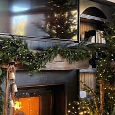 a fireplace decorated for christmas with garland and lights