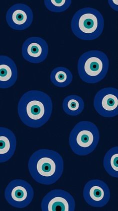 an image of blue and white eyeballs on a dark background with green circles in the middle