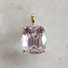 This stunning pendant is set in 14K Solid Yellow Gold with Natural Kunzite with utmost precision. It is an unique gemstone pendant for nearly every occasion and is completely hassle-free jewelry. ITEM DETAILS * Gem: Kunzite * Gem Size: 12X14mm * Gem Shape: Rectangle * Gem Weight: 6.11 carats * Gold Purity: 14KT  * Gold Weight: 1.15 gram * Total Weight of the Pendant: 3.59 gram The Gold purity is guaranteed and it comes with authentic 14KT gold hallmark. Since my items are handmade, they are absolutely nickel and lead free. CUSTOMIZATION * Gemstone customization is available and it can be substituted with a gem of your choice. Kindly message me for the same. PACKAGING * The Pendant comes with layers of safe and secure wrapping along with Free handmade jewelry box with every purchase. ➡️Head Yellow Gold Jewelry With Kunzite Gemstones, Yellow Gold Kunzite Jewelry Gift, Yellow Gold Kunzite Jewelry As A Gift, Formal Kunzite Jewelry With Prong Setting, Classic Yellow Gold Jewelry With Large Stone, 14k Yellow Gold Jewelry With Large Stone, Luxury 14k Gold Jewelry With Large Stone, Gift Jewelry With Prong Setting In Kunzite, Elegant Gemstones With Large Stone For Gift