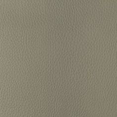 a close up view of the grained surface of a beige leather textured material