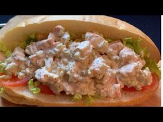 a chicken salad sandwich with lettuce and tomatoes