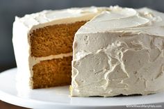 a cake with white frosting sitting on top of a plate