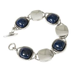 Amazing silver bracelet by Arvo Saarela, with concave silver links alternating with links with cabochon cut lapis lazuli stones. Elegantly chunky design. This piece has an attribution mark,   I am sure that it is completely authentic and  take full responsibility for any authenticity   issues arising from misattribution Silver Metal Bracelet With Cabochon, Luxury Silver Bracelets With Cabochon, Modern Lapis Lazuli Jewelry With Polished Finish, Silver Lapis Lazuli Jewelry For Formal Events, Silver Lapis Lazuli Jewelry For Formal Occasions, Formal Silver Lapis Lazuli Jewelry, Silver Bracelets With Lapis Lazuli Natural Stones, Lapis Lazuli Stone, Lapis Lazuli