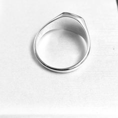 a silver ring sitting on top of a white table