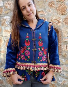 This gorgeous jacket started with a vintage hand embroidered Hungarian felt vest, completely handmade. We have embellished it by adding sleeves, lining and adding vintage trims. We also attached a peplum to make the jacket longer and more fun. We added beautiful brass hooks to close the jacket. The jacket is made of a deep blue wool (100% natural wool) the lining is a very sweet blue taffeta. Although it is vintage, the vest had clearly never been used.  It is of a nice weight, perfect for Fall Traditional Embellished Spring Outerwear, Folk Style Blue Outerwear For Fall, Blue Folk Style Outerwear For Fall, Blue Folk Style Fall Outerwear, Embroidered Long Sleeve Outerwear For Costume, Blue Folk Embroidered Outerwear, Blue Folk Style Embroidered Outerwear, Fitted Folk Style Embroidered Outerwear, Fitted Embroidered Folk Outerwear