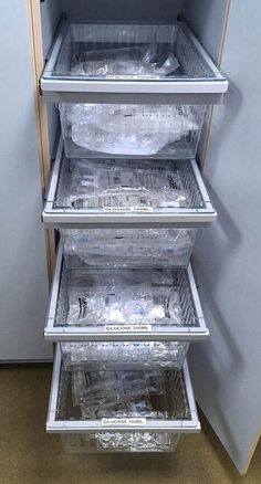 an open refrigerator with plastic containers in it