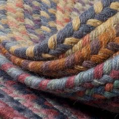 multicolored wool rugs stacked together on top of each other in different colors