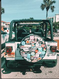 the back end of a jeep with stickers all over it's tire cover