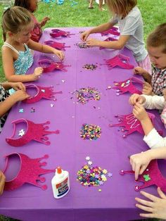 a purple table topped with lots of little kids