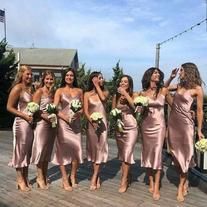 a group of women standing on top of a wooden deck