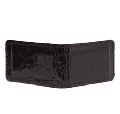 This luxe glazed black alligator money clip is designed with a rectangular shape and hinged back to securely hold folded banknotes and cards. A practical luxury and excellent gift item. Rectangular shape with stitched edges Black color; glazed finish Magnetic closure to securely hold cards and currency notes Size: 2" x 1-1/2" folded Genuine American alligator Handmade in America Formal Rectangular Card Holder With Crocodile Pattern, Formal Crocodile Pattern Rectangular Card Holder, Formal Rectangular Crocodile Pattern Card Holder, Elegant Rectangular Crocodile Pattern Card Holder, Elegant Crocodile Pattern Card Holder, Classic Wallet With Crocodile Pattern, Black Rectangular Card Holder For Formal Occasions, American Alligator, Currency Note