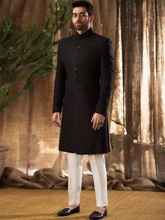 Sherwani:Color: BlackFabric: Raw SilkSherwani features rich quality embellishments accent on collarFanciful front button closure  Inner:Comes with off-white kurta and pajama  Additional Accessories:Jodhpuri/Saleem Shahi Shoes: US$30 (Made with sherwani material & embroidery)  Note: Price of all sherwani suits includes only 3 pieces i.e. sherwani, kurta and pajama (or whatever bottom is mentioned in product description). Extra charges will apply for any additional accessories like shawl, turb Designer Long Sleeve Sherwani For Festive Occasion, Designer Sherwani With Chikankari Embroidery And Long Sleeves, Designer Long Sleeve Sherwani With Chikankari Embroidery, Designer Long Sleeve Bandhgala For Diwali, Designer Long Sleeve Traditional Wear For Festive Season, Designer Long Sleeve Kurta, Designer Straight Kurta For Eid, Traditional Fit Long Sleeve Sherwani With Chikankari Embroidery, Festive Long Sleeve Traditional Fit Sherwani