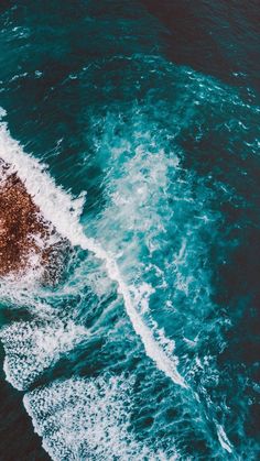 an aerial view of the ocean with waves