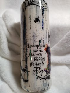 a white ceramic bottle with writing on it